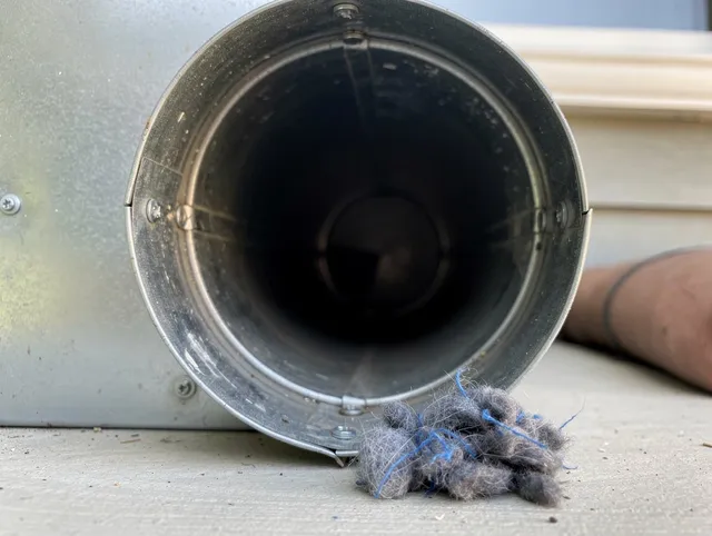 Gainesville Dryer Vent Cleaning technician using specialized equipment to clear severe dryer vent blockage in Gainesville